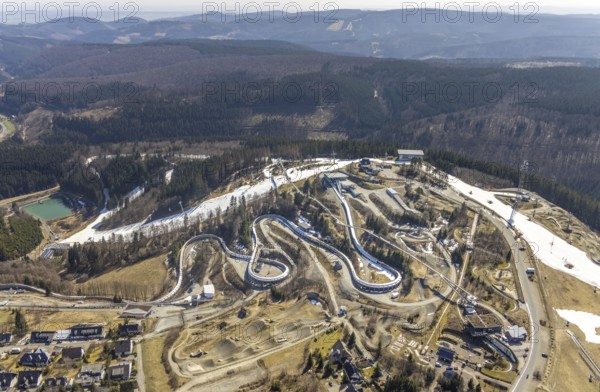 Veltins EisArena luge track and bobsleigh run, Winterberg, Sauerland, North Rhine-Westphalia, Germany, bobsleigh, DE, Europe, artificial ice rink, aerial view, aerial photography, aerial photography, pandemic lockdown, luge, snow remains, overview, bird's eye view, forest area, winter, birds-eyes view, overview