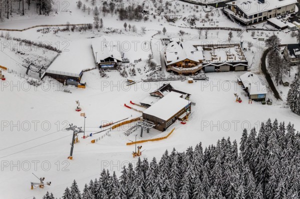 Aerial view of the snowy winter landscape of Winterberg with deserted ski lifts and slopes during the corona-related lockdown in Sauerland in North Rhine-Westphalia, Germany, Sauerland, Europe, aerial photo, birds-eyes view, aerial photography, aerial photography, overview, bird's eye view, lockdown, closed winter landscape, corona lockdown, deserted, snow, winter weather, corona-related lockdown