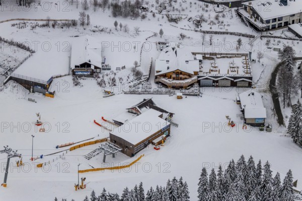 Aerial view of the snowy winter landscape of Winterberg with deserted ski lifts and slopes during the corona-related lockdown in Sauerland in North Rhine-Westphalia, Germany, Sauerland, Europe, aerial photo, birds-eyes view, aerial photography, aerial photography, overview, bird's eye view, lockdown, closed winter landscape, corona lockdown, deserted, snow, winter weather, corona-related lockdown