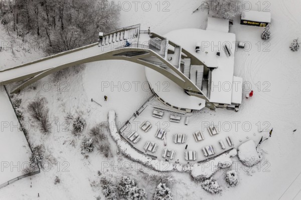 Aerial view of the snowy winter landscape of Winterberg with the St. Georg ski jump in the Sauerland in North Rhine-Westphalia, Germany, Sauerland, Europe, aerial photo, birds-eyes view, aerial photography, aerial photography, overview, bird's eye view, lockdown, closed winter landscape, corona lockdown, deserted, snow, winter weather, corona-related lockdown