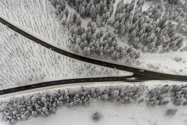 Aerial view of the snowy winter landscape of Winterberg with winding roads and paths with a V-shaped fork in the road in Sauerland in North Rhine-Westphalia, Germany, Sauerland, Europe, aerial photo, birds-eyes view, aerial photography, aerial photography, overview, bird's eye view, lockdown, closed winter landscape, corona lockdown, deserted, snow, winter weather, corona-related lockdown