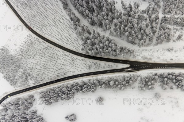 Aerial view of the snowy winter landscape of Winterberg with winding roads and paths with a V-shaped fork in the road in Sauerland in North Rhine-Westphalia, Germany, Sauerland, Europe, aerial photo, birds-eyes view, aerial photography, aerial photography, overview, bird's eye view, lockdown, closed winter landscape, corona lockdown, deserted, snow, winter weather, corona-related lockdown