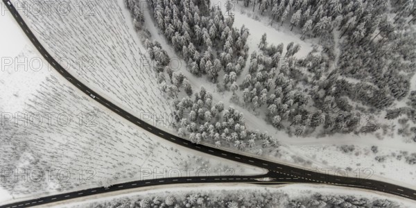 Aerial view of the snowy winter landscape of Winterberg with winding roads and paths with a V-shaped fork in the road in Sauerland in North Rhine-Westphalia, Germany, Sauerland, Europe, aerial photo, birds-eyes view, aerial photography, aerial photography, overview, bird's eye view, lockdown, closed winter landscape, corona lockdown, deserted, snow, winter weather, corona-related lockdown