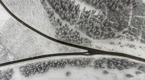Aerial view of the snowy winter landscape of Winterberg with winding roads and paths with a V-shaped fork in the road in Sauerland in North Rhine-Westphalia, Germany, Sauerland, Europe, aerial photo, birds-eyes view, aerial photography, aerial photography, overview, bird's eye view, lockdown, closed winter landscape, corona lockdown, deserted, snow, winter weather, corona-related lockdown