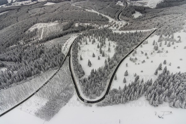 Aerial view of the snowy winter landscape of Winterberg with winding roads and paths in the Sauerland in North Rhine-Westphalia, Germany, Sauerland, Europe, aerial photo, birds-eyes view, aerial photography, aerial photography, overview, bird's eye view, lockdown, closed winter landscape, corona lockdown, deserted, snow, winter weather, corona-related lockdown