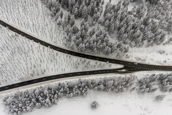 Aerial view of the snowy winter landscape of Winterberg with winding roads and paths with a V-shaped fork in the road in Sauerland in North Rhine-Westphalia, Germany, Sauerland, Europe, aerial photo, birds-eyes view, aerial photography, aerial photography, overview, bird's eye view, lockdown, closed winter landscape, corona lockdown, deserted, snow, winter weather, corona-related lockdown