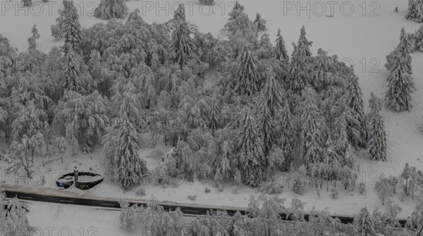 Aerial view of the snowy winter landscape of Winterberg below the Kahler Asten with snow-covered trees and firs in the Sauerland in North Rhine-Westphalia, Germany, Sauerland, Europe, aerial photo, birds-eyes view, aerial photography, aerial photography, overview, bird's eye view, lockdown, closed winter landscape, corona lockdown, deserted, snow, winter weather, corona-related lockdown, high heath in winter