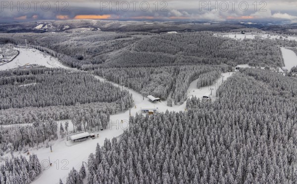 Aerial view of the snowy winter landscape of Winterberg with deserted ski lifts and slopes during the corona-related lockdown in the Sauerland in North Rhine-Westphalia, Germany, Sauerland, Europe, aerial photo, birds-eyes view, aerial photography, aerial photography, overview, bird's eye view, lockdown, closed winter landscape, corona lockdown, deserted, snow, winter weather, corona-related lockdown, high heath in winter
