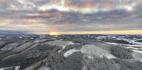 Aerial view of the sunset with a view over the snowy winter landscape from Winterberg to the Bergisches Land in Sauerland in North Rhine-Westphalia, Germany, Sauerland, Europe, aerial view, birds-eyes view, aerial photography, aerial photography, overview, bird's eye view, lockdown, closed winter landscape, corona lockdown, deserted, snow, winter weather, corona-related lockdown