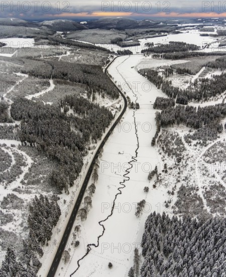 Aerial view of the Ruhr valley with the meandering Ruhr as a stream in the snowy winter landscape of Winterberg in Sauerland in North Rhine-Westphalia, Germany, Sauerland, Europe, aerial view, birds-eyes view, aerial photography, aerial photography, overview, bird's eye view, lockdown, closed winter landscape, corona lockdown, deserted, snow, winter weather, corona-related lockdown