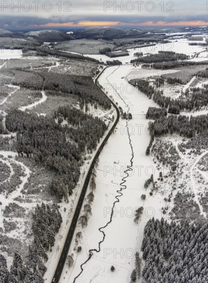 Aerial view of the Ruhr valley with the meandering Ruhr as a stream in the snowy winter landscape of Winterberg in Sauerland in North Rhine-Westphalia, Germany, Sauerland, Europe, aerial view, birds-eyes view, aerial photography, aerial photography, overview, bird's eye view, lockdown, closed winter landscape, corona lockdown, deserted, snow, winter weather, corona-related lockdown