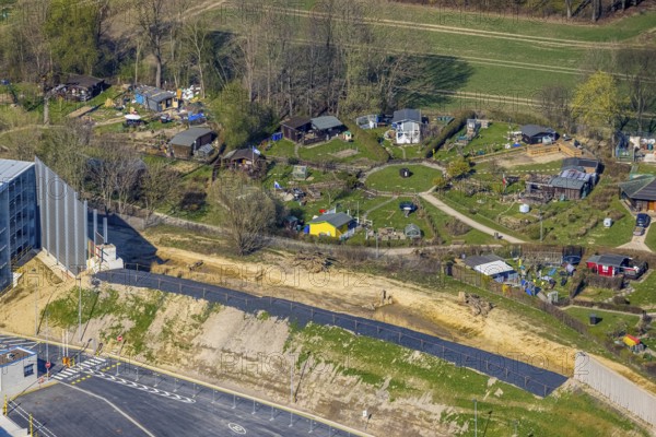 Aerial view, allotment garden site Mellmausland next to the Amazon site on the industrial estate on Brauckstraße, Rüdinghausen, Witten, Ruhr area, North Rhine-Westphalia, Germany, DE, Europe, community garden, allotment garden, allotment garden site, allotment garden association, aerial view, aerial photography, aerial photography, Menglinghauser Straße, allotment garden, overview, bird's-eye view, overview, shadow of the noise barrier, construction of a noise barrier