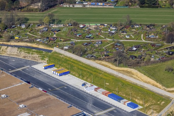 Aerial view, allotment garden site Mellmausland next to the Amazon site on the industrial estate on Brauckstraße, Rüdinghausen, Witten, Ruhr area, North Rhine-Westphalia, Germany, DE, Europe, community garden, allotment garden, allotment garden site, allotment garden association, aerial view, aerial photography, aerial photography, Menglinghauser Straße, allotment garden, overview, bird's-eye view, overview, shadow of the noise barrier, construction of a noise barrier