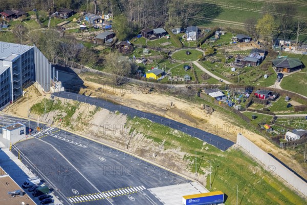 Aerial view, allotment garden site Mellmausland next to the Amazon site on the industrial estate on Brauckstraße, Rüdinghausen, Witten, Ruhr area, North Rhine-Westphalia, Germany, DE, Europe, community garden, allotment garden, allotment garden site, allotment garden association, aerial view, aerial photography, aerial photography, Menglinghauser Straße, allotment garden, overview, bird's-eye view, overview, shadow of the noise barrier, construction of a noise barrier