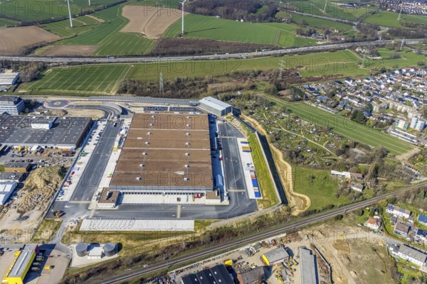Aerial view, construction site new building Amazon logistics centre, industrial estate on Brauckstraße, allotment garden site Mellmausland, Rüdinghausen, Witten, Ruhr area, North Rhine-Westphalia, Germany, Amazon logistics centre, railway tracks, construction work, construction area, building site, building plots, construction measure, construction project, building site, DE, Ennepe-Ruhr district, development, Europe, community garden, commercial enterprises, commercial area, commercial park, commercial site, commercial use, freight traffic, industrial estate, industrial building, industrial site, allotment garden, allotment garden site, allotment garden association, allotment gardener association, logistics, logistics service, logistics provider, logistics centre, aerial view, aerial photography, aerial photography, Menglinghauser Straße, new build, parcel delivery, Salinger Feld, allotment garden, freight forwarding, transport, transport service, overview, bird's-eye view, overview