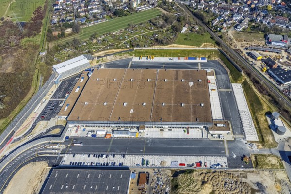 Aerial view, construction site new building Amazon logistics centre, industrial estate on Brauckstraße, allotment garden site Mellmausland, Rüdinghausen, Witten, Ruhr area, North Rhine-Westphalia, Germany, Amazon logistics centre, railway tracks, construction work, construction area, building site, building plots, construction measure, construction project, building site, DE, Ennepe-Ruhr district, development, Europe, community garden, commercial enterprises, commercial area, commercial park, commercial site, commercial use, freight traffic, industrial estate, industrial building, industrial site, allotment garden, allotment garden site, allotment garden association, allotment gardener association, logistics, logistics service, logistics provider, logistics centre, aerial view, aerial photography, aerial photography, Menglinghauser Straße, new build, parcel delivery, Salinger Feld, allotment garden, freight forwarding, transport, transport service, overview, bird's-eye view, overview