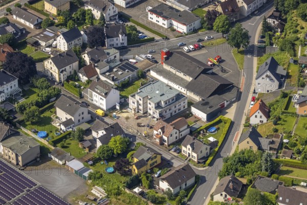 Aerial photo, Wickede Volunteer Fire Brigade, construction site, new residential building on Neue Straße, Wickede, Sauerland, North Rhine-Westphalia, Germany, construction work, construction area, building site, building plots, construction project, construction site, fire fighters, fire protection, fire station, DE, Europe, fire station, fire brigade, property tax, real estate, aerial view, aerial photography, aerial photography, new building, La rue nouvelle project, rescue station, overview, bird's-eye view, residential complex, living and life, residential area, residential buildings, birds-eyes view, overview