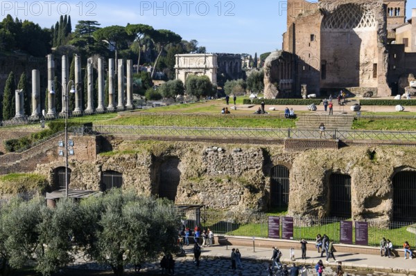 Foundations of the substructure of the Temple of Venus and Roma, Arch of Titus on the left in the background, Rome, Lazio, Italy