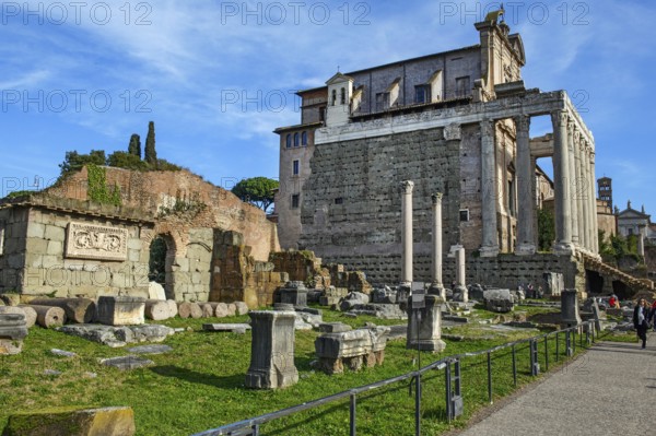 In the background, former temple of Antoninus and Faustina with columns made of Cipollin marble from antiquity, converted into a Christian church from the 7th century, today San Lorenzo in Miranda, in front square and remains of Basikika Aemilia, Forum Romanum, Rome, Lazio, Italy
