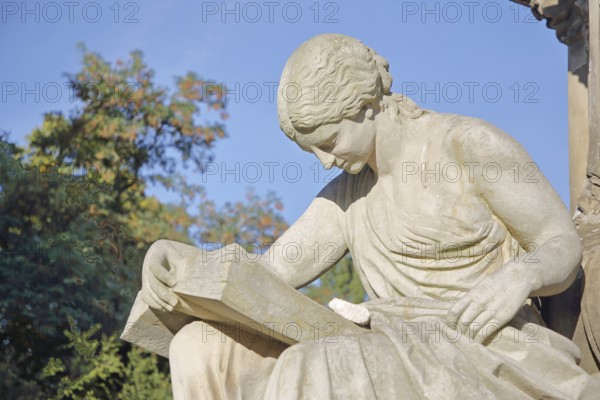 Seated white female figure reading a thick book as a symbol of science, allegory, knowledge, reading, monument to Lord Mayor Gustav Hasselbach, book reader, fountain, Hasselbach fountain, Haydnplatz, Magdeburg