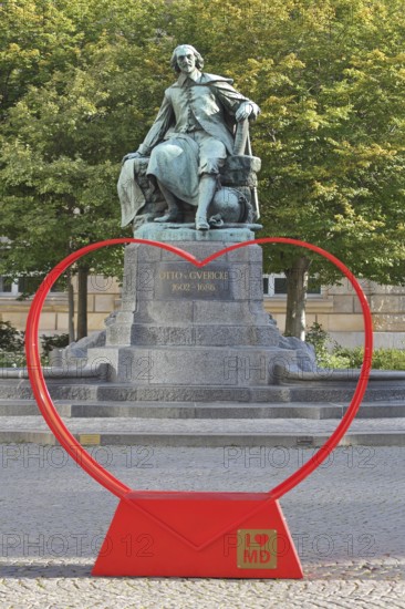 Red heart with I like MD and Otto von Guericke Fountain, monument, sculpture, inscription, view, through, heart-shaped, letter, sign, symbol for love, solidarity, love, perspective, abbreviation, letters, New Town Hall, Hauptwache, Magdeburg, Saxony-Anhalt, Germany