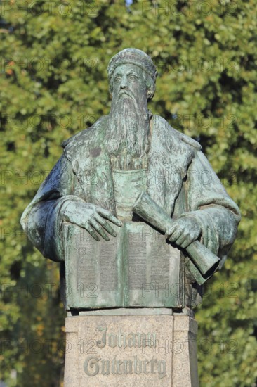 Monument to Johannes Gutenberg with book and scroll, bronze sculpture, inscription, Gutenberg monument, Magdeburg, Saxony-Anhalt, Germany