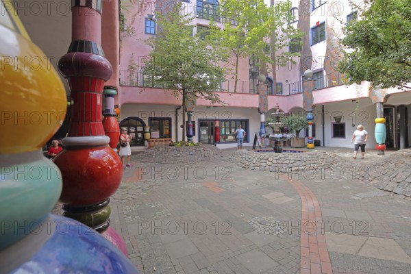 Colourful columns in the inner courtyard with fountain, Green Citadel, Hundertwasser House, Magdeburg, Saxony-Anhalt, Germany