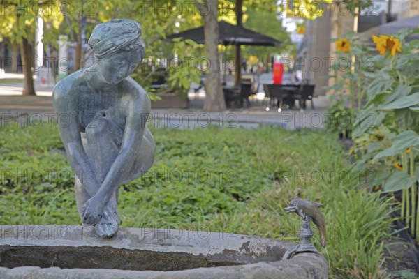 Sculpture Bathing Girl by Heinrich Apel 1972, bronze sculpture, modern art, bathing female figure with one leg on water basin above, looking, gazing, watching, dolphin figure, Magdeburg, Saxony-Anhalt, Germany