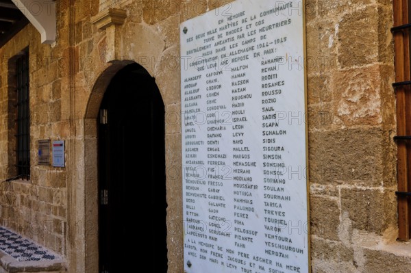 Memorial plaque with names on an old stone wall in a town, Kahal Shalom Synagogue, Sephardic Synagogue, Oldest Synagogue in Greece, Synagogue, Jewish Quarter, Rhodes Old Town, Rhodes Town, Rhodes, Dodecanese, Greek Islands, Greece