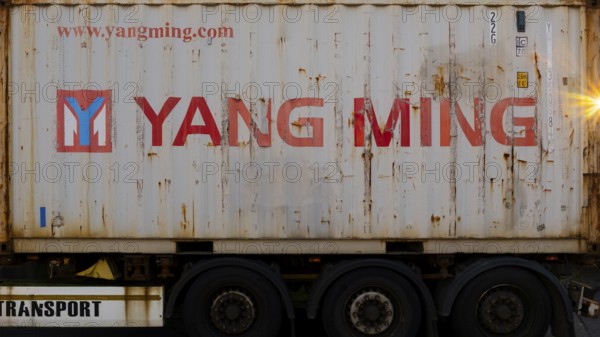 Photograph of a heavily loaded container standing on a trailer, Garbsen, Hanover Lower Saxony, Germany