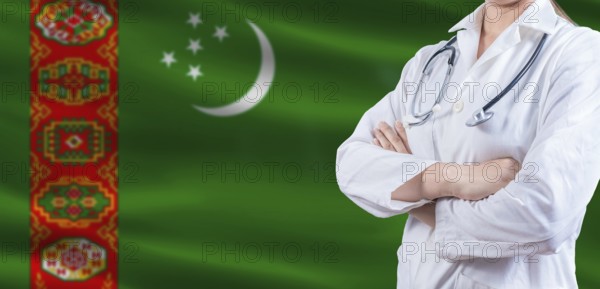 Doctor with crossed arms on Turkmenistan flag. Turkmen health and care concept. Female doctor on Turkmenistan flag