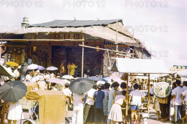 Audience watching Chinese theatre performance at the old market, Johor Bahru, Johor, Malaya, Malaysia, south east Asia 1963