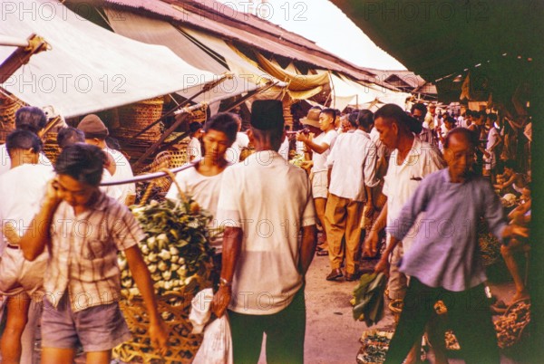 Porters with vegetables people shopping at the old market, Johor Bahru, Johor, Malaya, Malaysia, south east Asia 1963
