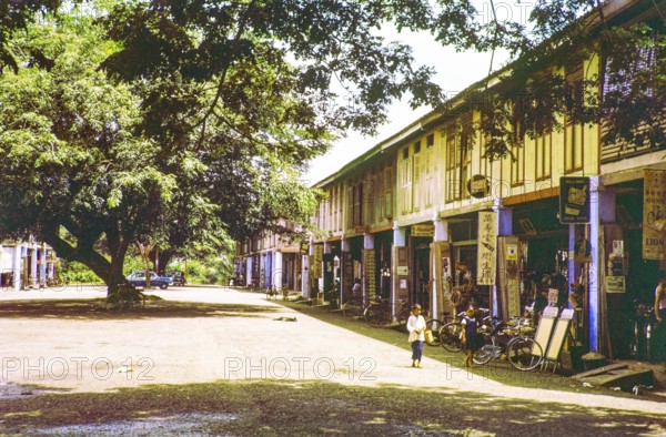 Row of Chinese shophouses businesses in building, unspecified location in Malaya, Malaysia, south east Asia 1963