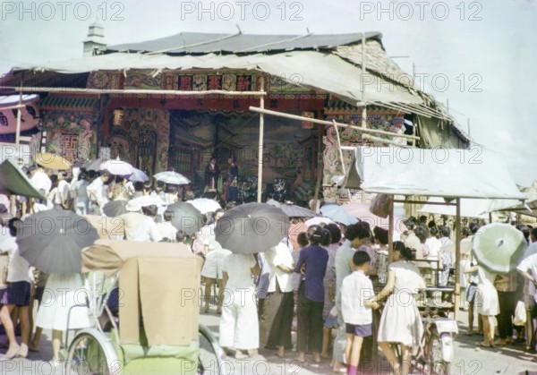 Audience watching Chinese theatre performance at the old market, Johor Bahru, Johor, Malaya, Malaysia, south east Asia 1963