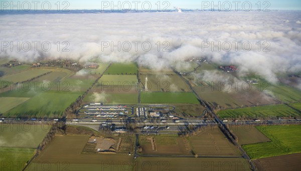 Aerial view, fog over Büderich and Holtum as well as construction site and extension of the motorway service area Am Haarstrang of the A44 in the district Westbüderich in Werl, Sauerland, North Rhine-Westphalia, Germany, motorway A44, DE, Europe, shapes and colours, aerial view, aerial photography, aerial photography, fog, service area, service area, overview, bird's eye view, Werl, clouds, birds-eyes view, overview