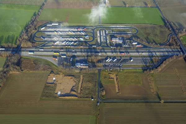Aerial view, construction site and expansion of the motorway service area Am Haarstrang of the A44 in the district Westbüderich in Werl, Sauerland, North Rhine-Westphalia, Germany, motorway A44, DE, Europe, shapes and colours, aerial view, aerial photography, aerial photography, fog, rest area, service area, overview, bird's eye view, Werl, clouds, birds-eyes view, overview