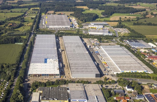 Large warehouses in an industrial area, framed by fields and scattered trees, aerial view Werl overview, Amazon distribution centre Werne, Werne, North Rhine-Westphalia, Germany