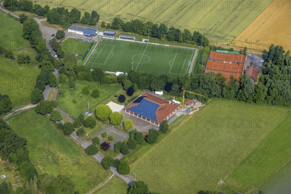 Aerial view, sports ground DJK - Blau Weiß Büderich, Kuniberthalle Büderich Schützenhalle with solar roof, Westbüderich, Werl, Soester Börde, North Rhine-Westphalia, Germany, DE, Europe, football pitch, football stadium, aerial view, aerial photography, aerial photography, photovoltaics, photovoltaic system, shooting hall, solar, solar system, solar roof, solar energy, solar energy, sports, sports facilities, sports field, sports facility, tennis, tennis facility, tennis courts, overview, venue, event location, bird's-eye view, birds-eyes view, overview
