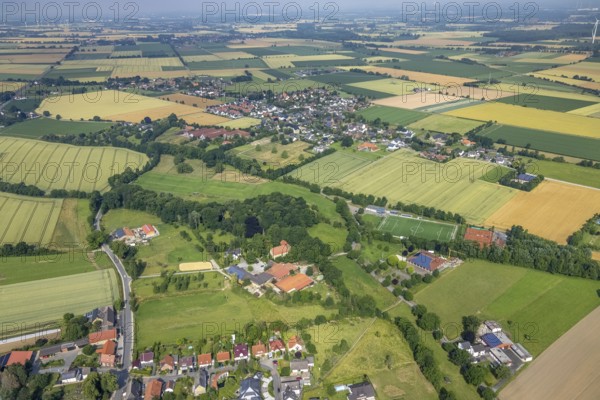 Aerial view, sports field DJK - Blau Weiß Büderich, Kuniberthalle Büderich Schützenhalle with solar roof, Westbüderich and Holtum, Werl, Soester Börde, North Rhine-Westphalia, Germany, DE, Europe, football field, football stadium, aerial view, aerial photography, aerial photography, photovoltaics, photovoltaic system, shooting hall, solar, solar system, solar roof, solar energy, solar energy, sports, sports facilities, sports field, sports facility, tennis, tennis facility, tennis courts, overview, event location, event venue, bird's-eye view, meadows and fields, birds-eyes view, overview