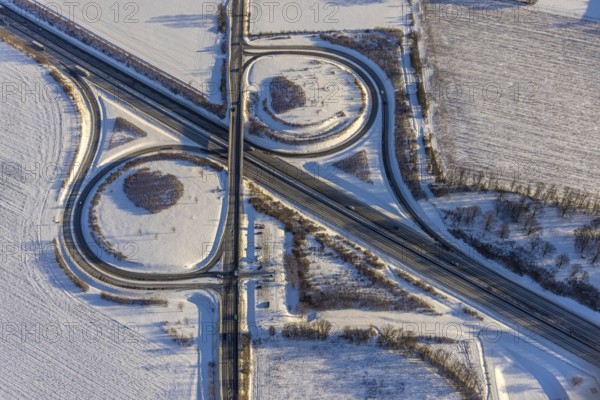 Aerial view, motorway junction AS55 Werl-Süd on the motorway A44, federal road B516 Neheimer Straße, car park Werl-Süd, winter, snow, Werl, Soester Börde, North Rhine-Westphalia, Germany, Soester, Börde, DE, Europe, birds-eyes, view, aerial photography, aerial photography, aerial photography, overview, overview, bird's eye view, A44, motorway junction, AS55, B516, transport, traffic, infrastructure, logistics, road traffic, snow