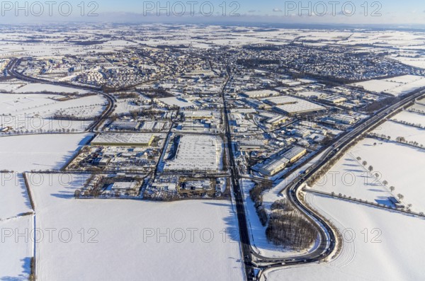 Aerial view, motorway access to the A445 motorway on the B63 Hammer Landstraße federal road, industrial area, commercial area, snow, winter, Budberg, Werl, Soester Börde, North Rhine-Westphalia, Germany, Soester, Börde, DE, Europe, birds-eyes, view, aerial photograph, aerial photography, aerial photography, overview, overview, bird's eye view, A445, B63, industry, commerce, economy, commercial enterprise, production, trade, manufacturing, transport, traffic, infrastructure, logistics, road traffic
