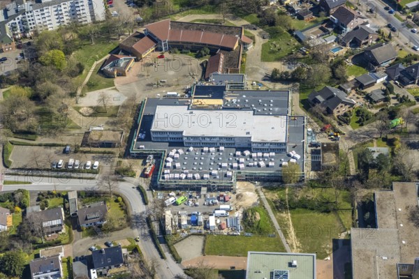 Aerial view, construction site roof renovation and remodelling of the Comenius comprehensive school, Voerde, Ruhr area, Lower Rhine, North Rhine-Westphalia, Germany, construction work, construction project, construction site, DE, Europe, aerial view, aerial photography, aerial photography, renovation, refurbishment, overview, bird's-eye view, overview