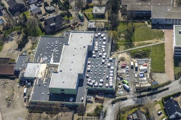 Aerial view, construction site roof renovation and remodelling of the Comenius comprehensive school, Voerde, Ruhr area, Lower Rhine, North Rhine-Westphalia, Germany, construction work, construction project, construction site, DE, Europe, aerial view, aerial photography, aerial photography, renovation, refurbishment, overview, bird's-eye view, overview