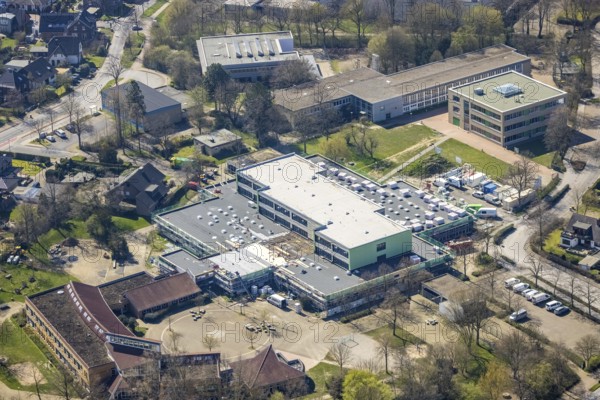 Aerial view, construction site roof renovation and remodelling of the Comenius comprehensive school, Voerde, Ruhr area, Lower Rhine, North Rhine-Westphalia, Germany, construction work, construction project, construction site, DE, Europe, aerial view, aerial photography, aerial photography, renovation, refurbishment, overview, bird's-eye view, overview