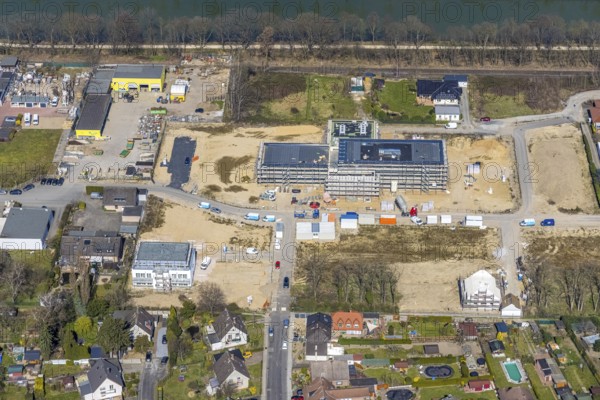 Aerial view, construction site and new building in the Friedrichsfeld industrial estate, Poststrasse, Friedrichsfeld, Voerde, Ruhr area, Lower Rhine, North Rhine-Westphalia, Germany, construction work, construction area, building site, building plots, construction project, construction site, DE, Europe, commercial enterprises, commercial area, commercial area, commercial site, commercial use, industrial area, industrial site, aerial photograph, aerial photography, aerial photography, new building, overview, bird's eye view, birds-eyes view, overview