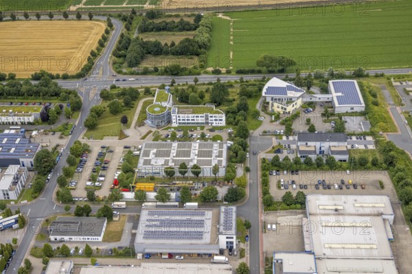 Aerial view, company building PVS / Westfalen-Süd rkV medical billing, Stadtwerke Unna, commercial area Physikerstraßen, Ülzen, Unna, Ruhr area, North Rhine-Westphalia, Germany, DE, Europe, shapes and colours, commercial enterprises, commercial area, commercial park, commercial location, commercial use, industrial area, industrial location, aerial view, aerial photography, aerial photography, photovoltaic, photovoltaic system, solar, solar system, solar roof, solar energy, solar energy, overview, bird's-eye view, birds-eyes view, overview