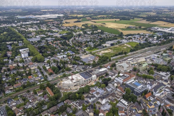 Aerial view, construction site and new shopping centre, former Bremme mill site, Unna railway station, town hall, Catholic Church St. Katharina, construction area Viktoriastraße for office building, Unna, Ruhr area, North Rhine-Westphalia, Germany, place of worship, railway tracks, railway station, construction work, construction area, construction site, building plots, construction project, construction site, authority, DE, Deutsche Bahn AG, shopping centre, Europe, religious community, place of worship, central station, main station, holy place, Kantstraße, church, parish, denomination, junction station, aerial view, aerial photography, aerial photography, new building, post office steps, religion, religious place, city administration, overview, bird's-eye view, birds-eyes view, overview