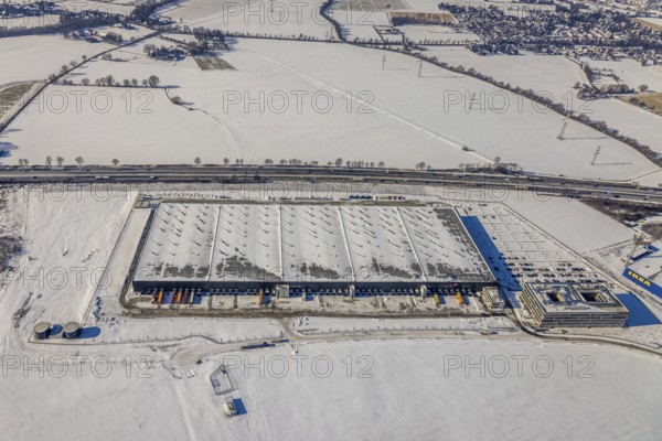 Aerial view, commercial area Unna-Kamen, central warehouse for Woolworth, ERL euro retail logistics GmbH, Afferde, Unna, Ruhr area, North Rhine-Westphalia, Germany, DE, Europe, commercial enterprises, commercial area, commercial area, commercial location, commercial use, industrial area, industrial location, aerial view, aerial photography, aerial photography, Mönninghoffsfeld, snow, overview, bird's-eye view, winter, onset of winter, winter landscape, birds-eyes view, overview