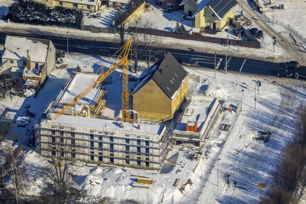 Aerial view, commercial area Unna-Kamen, construction site new building Hallohweg corner Kamener Straße, Afferde, Unna, Ruhr area, North Rhine-Westphalia, Germany, construction work, construction area, construction site, building plots, construction crane, construction project, construction site, DE, Europe, commercial enterprises, commercial area, commercial area, commercial site, commercial use, industrial area, industrial site, aerial view, aerial photography, aerial photography, Mönninghoffsfeld, new building, snow, overview, bird's-eye view, winter, winter landscape, birds-eyes view, overview